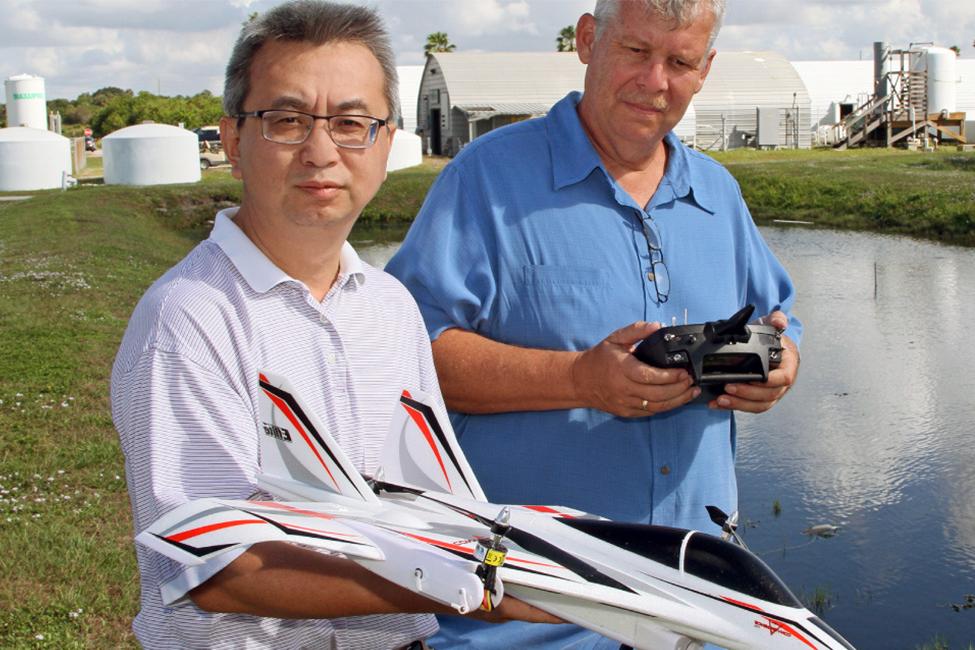 two scientist hold drones